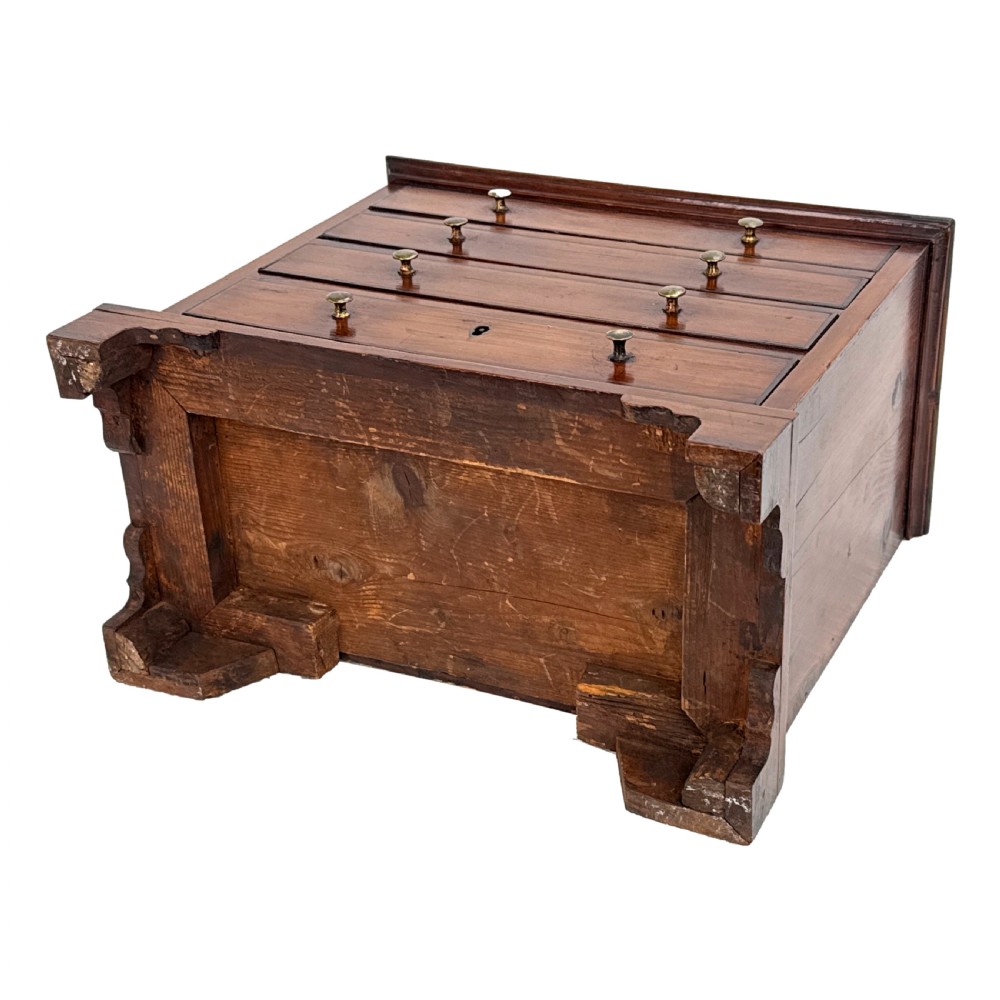 A Georgian miniature yew wood chest of four drawers featuring brass knobs, a keyhole escutcheon, and bracket feet. View VII