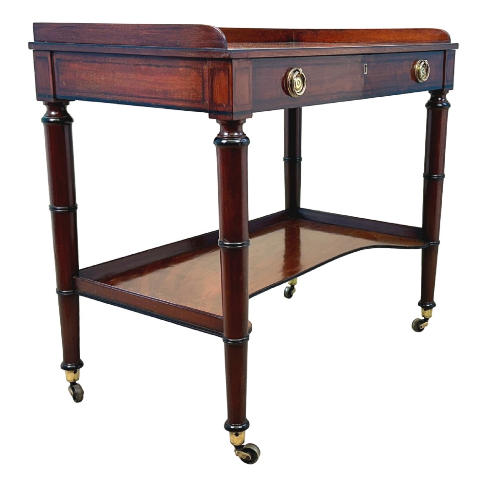 A 19th-century Georgian mahogany dressing table featuring a raised gallery top, single drawer with brass ring handles, undershelf, turned legs, and brass castors. View III