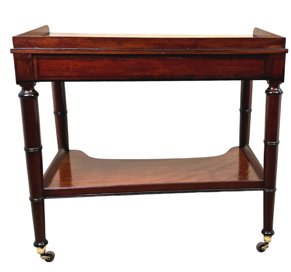 A 19th-century Georgian mahogany dressing table featuring a raised gallery top, single drawer with brass ring handles, undershelf, turned legs, and brass castors. View IV