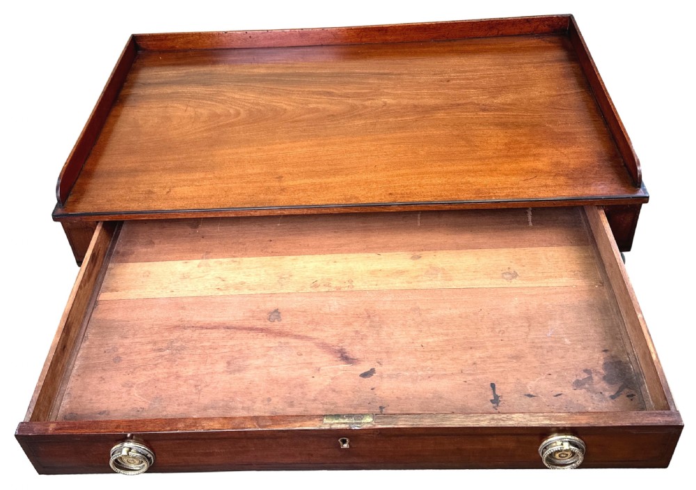 A 19th-century Georgian mahogany dressing table featuring a raised gallery top, single drawer with brass ring handles, undershelf, turned legs, and brass castors. View IX