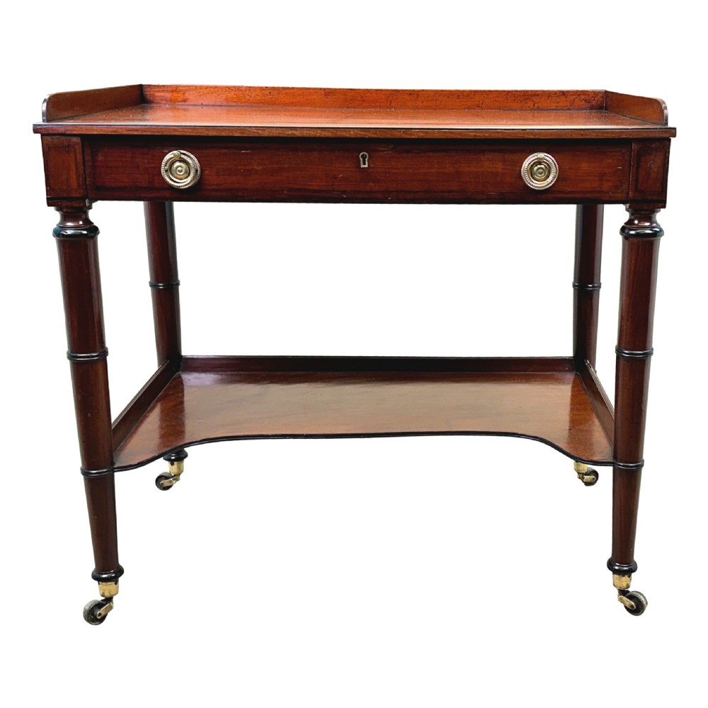 A 19th-century Georgian mahogany dressing table featuring a raised gallery top, single drawer with brass ring handles, undershelf, turned legs, and brass castors. View XI