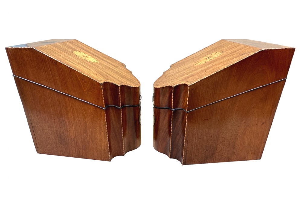 A pair of Georgian mahogany knife boxes featuring sloping lids with inlaid shell motifs, serpentine fronts, and metal keyhole escutcheons. View VIII