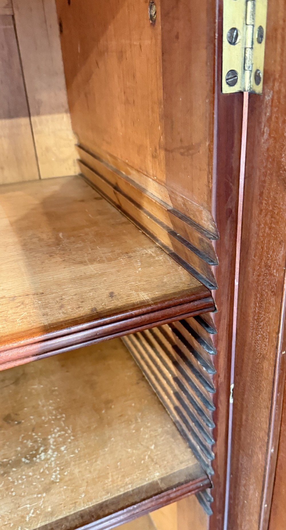 A Georgian mahogany breakfront bookcase featuring astragal glazed upper doors with Gothic arch tracery above panelled lower cupboards. View XII