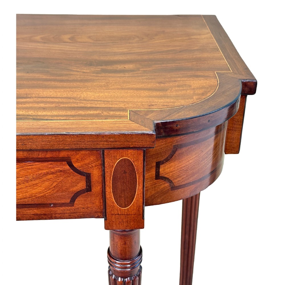 A Regency mahogany console table featuring reeded tapering legs, a shaped apron, and boxwood inlay detail. View III