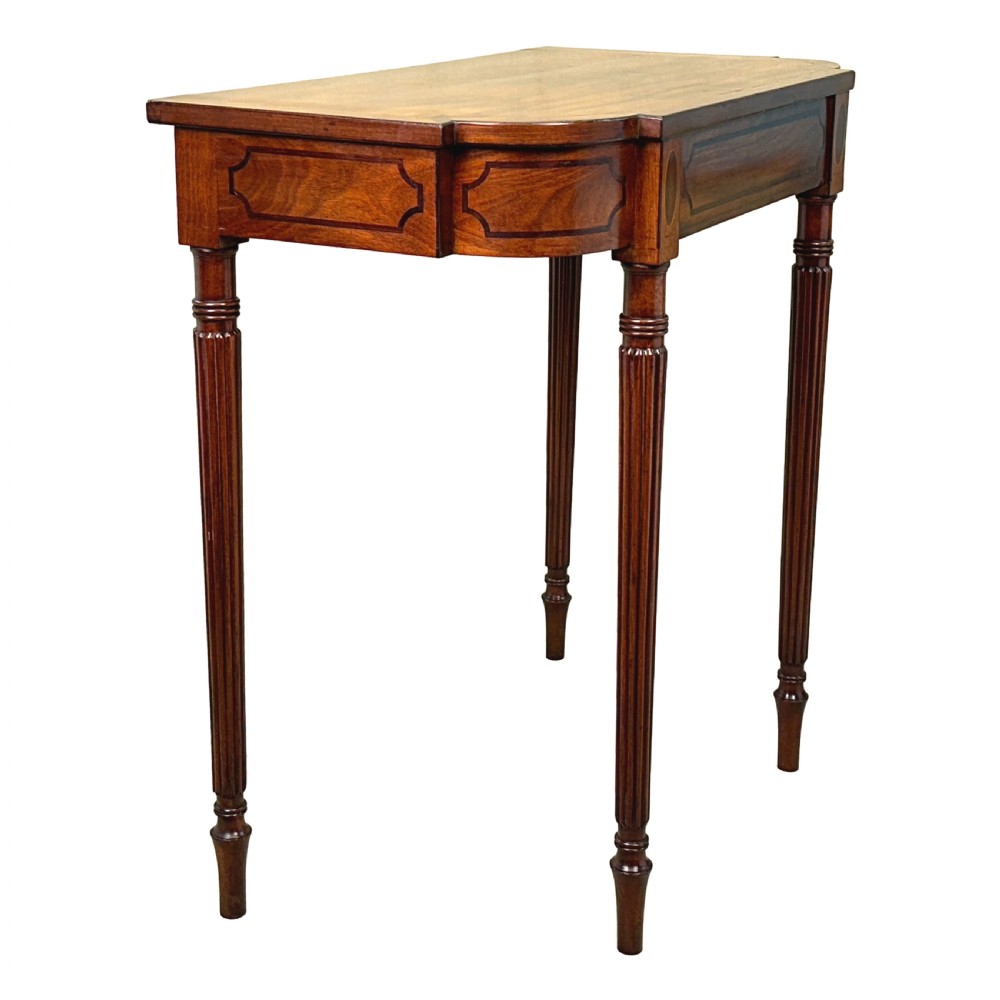 A Regency mahogany console table featuring reeded tapering legs, a shaped apron, and boxwood inlay detail. View V
