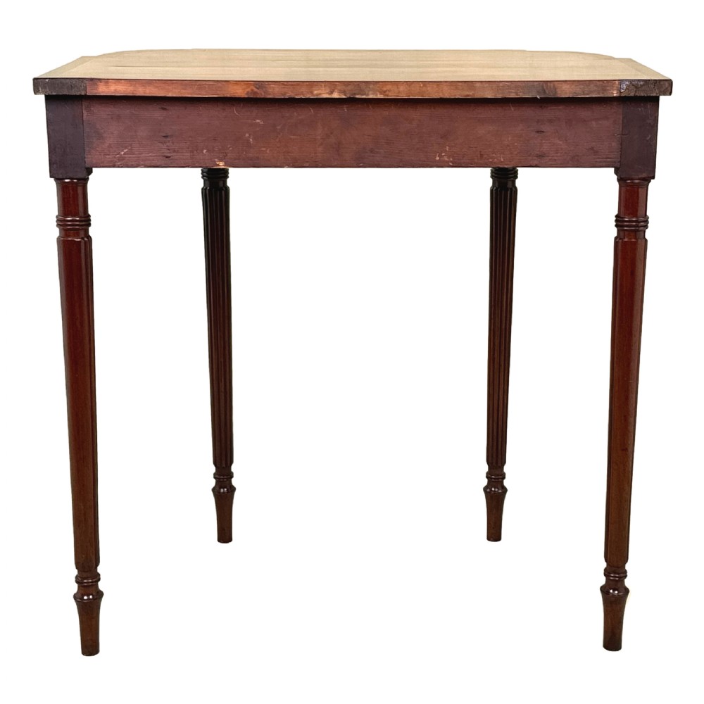 A Regency mahogany console table featuring reeded tapering legs, a shaped apron, and boxwood inlay detail. View VII