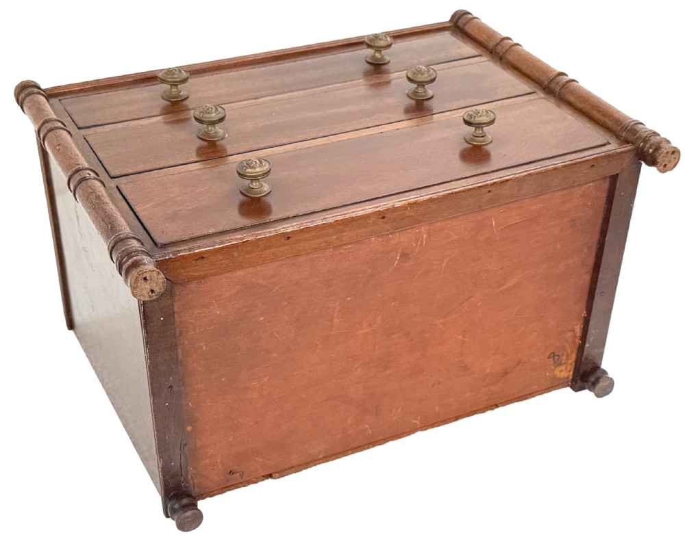 A Regency period miniature mahogany chest featuring three graduated drawers with round knobs and reeded corner columns. View VIII