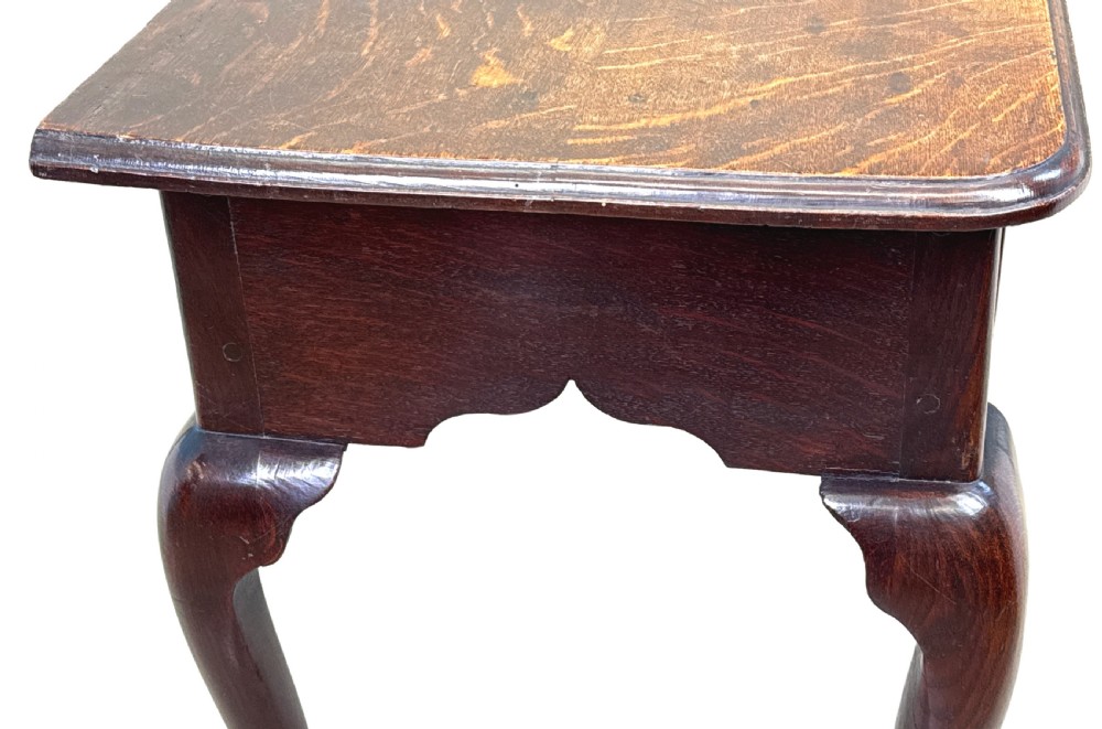 An 18th-century Georgian oak lowboy featuring three drawers with brass handles, a shaped apron, and four cabriole legs with pad feet. View VIII