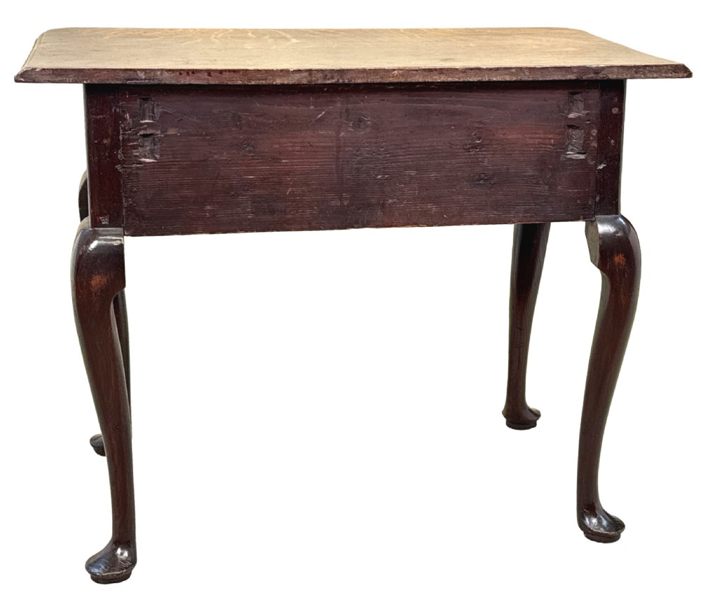 An 18th-century Georgian oak lowboy featuring three drawers with brass handles, a shaped apron, and four cabriole legs with pad feet. View IX