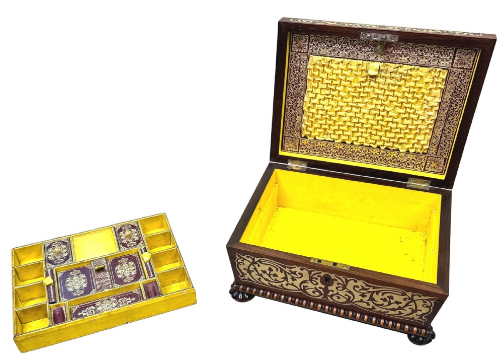 A Regency rosewood sarcophagus-shaped work box with brass foliate inlay, gadrooned mouldings, side handles, and carved feet. View XI