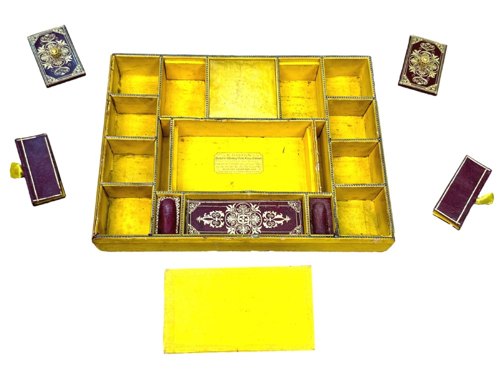 A Regency rosewood sarcophagus-shaped work box with brass foliate inlay, gadrooned mouldings, side handles, and carved feet. View XII