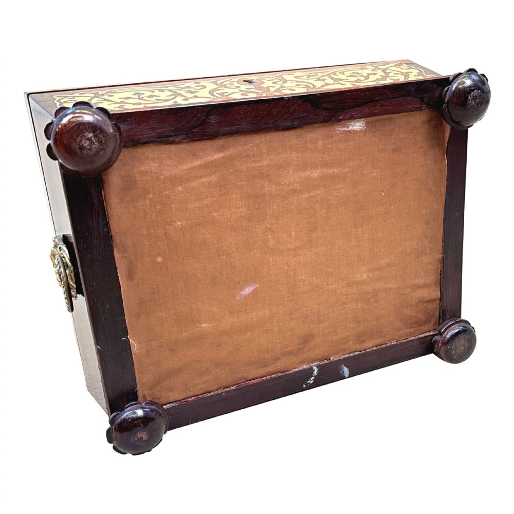A Regency rosewood sarcophagus-shaped work box with brass foliate inlay, gadrooned mouldings, side handles, and carved feet. View XVI