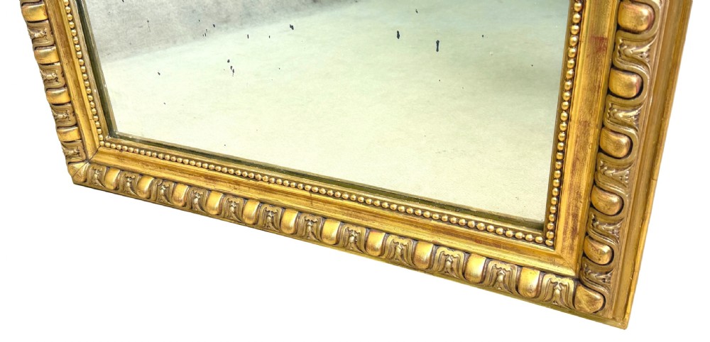 A 19th-century French rectangular wall mirror featuring a giltwood frame with rounded upper corners and beaded moulding detailing. View V