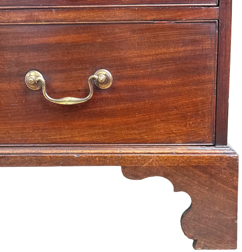 An 18th-century Chippendale mahogany cabinet on chest featuring upper cupboard doors with flame mahogany panels, a moulded cornice, and a lower section with four drawers on bracket feet. View IX