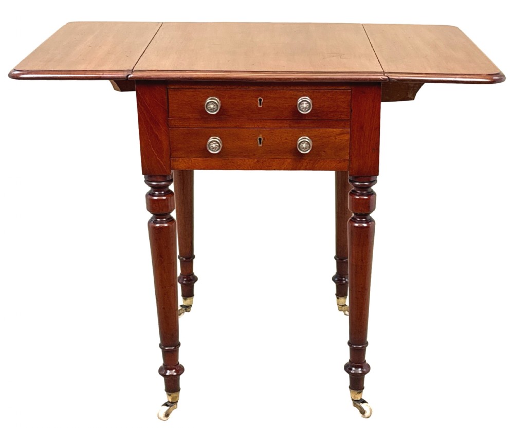 A nineteenth-century mahogany baby Pembroke table with two drawers, turned legs on brass castors, and drop-down side leaves. View IX