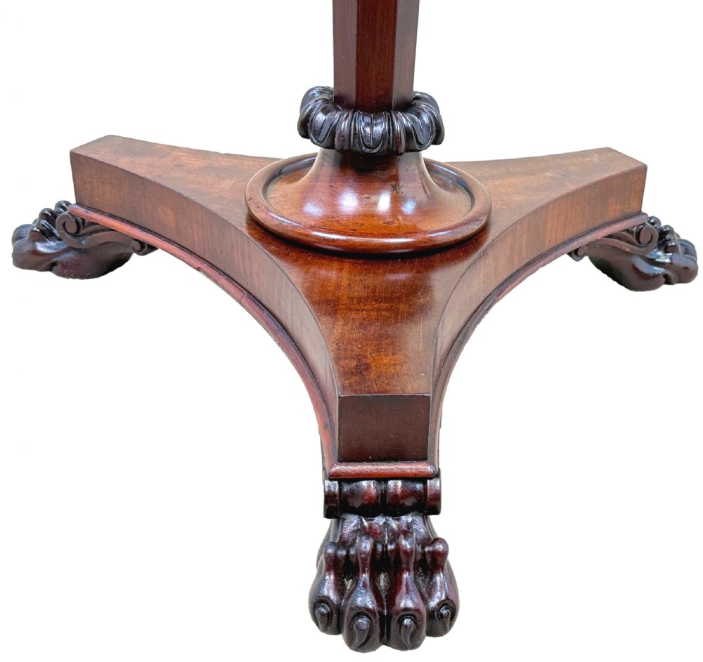A mid-19th century mahogany lamp table featuring an inlaid square chessboard on a round top, supported by a faceted pedestal and a tri-form base with carved feet. View VI