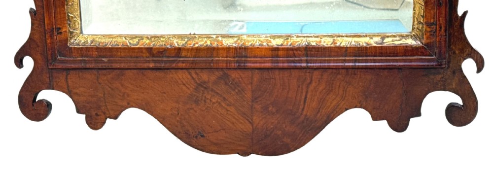 A George II walnut wall mirror featuring a scrolled architectural pediment, a central carved gilt shell motif, and a gilded inner sight edge. View III