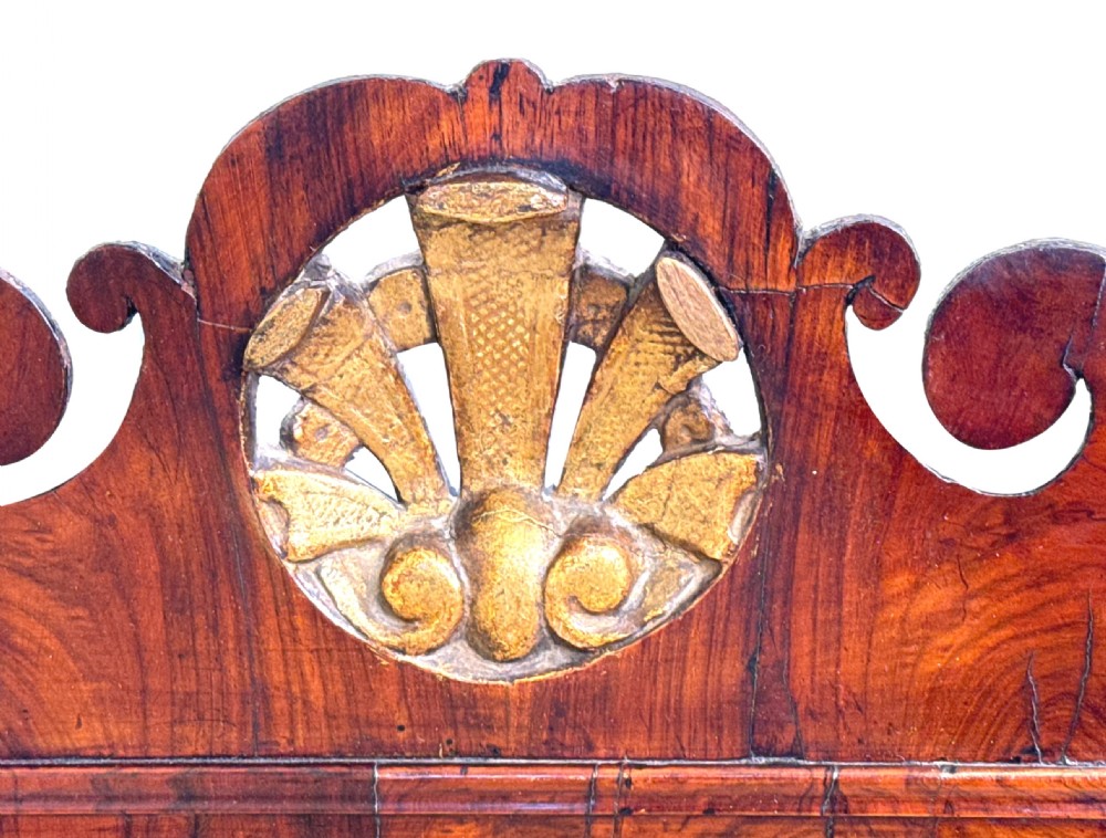 A George II walnut wall mirror featuring a scrolled architectural pediment, a central carved gilt shell motif, and a gilded inner sight edge. View VII