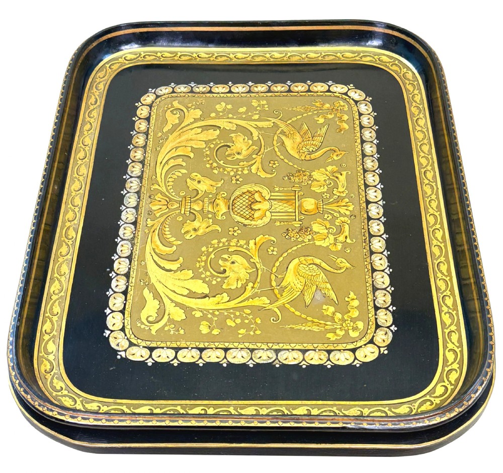 A 19th-century black papier-mache tray featuring gilded rim decoration, resting on a black turned wooden stand with gold accent rings. View IV