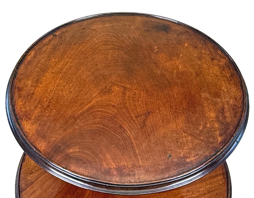 An 18th-century Georgian dark mahogany two-tier dumbwaiter featuring spiral turned details and a tripod base with cabriole legs. View II