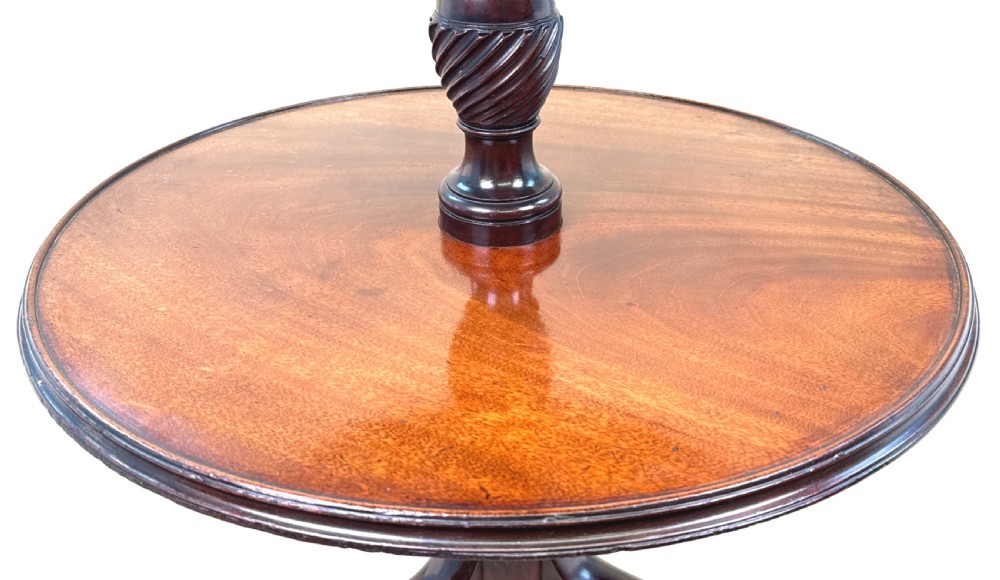 An 18th-century Georgian dark mahogany two-tier dumbwaiter featuring spiral turned details and a tripod base with cabriole legs. View VI