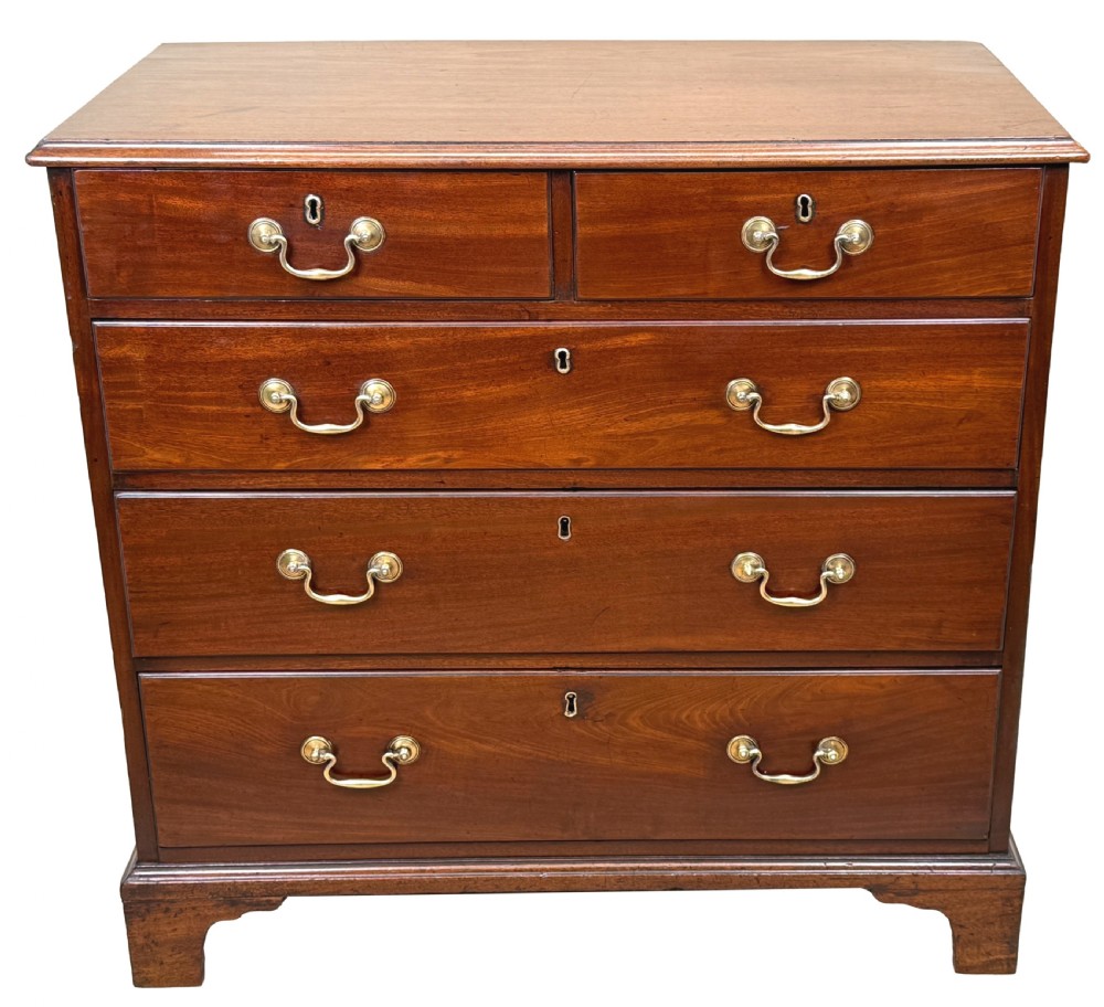 A George III mahogany chest of drawers featuring two short drawers over three long graduated drawers with brass swan-neck handles and bracket feet. View XI