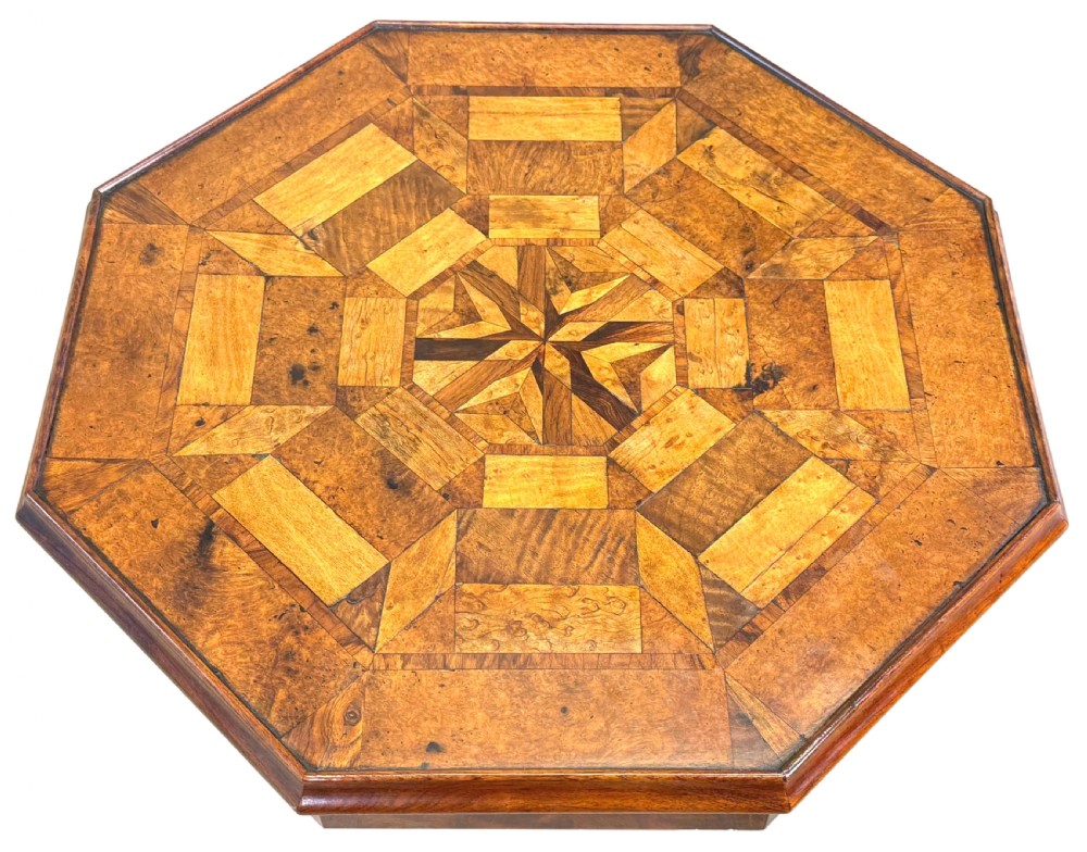 A nineteenth-century octagonal specimen wood occasional table featuring a geometric inlaid tabletop supported by a turned column and carved base. View VI