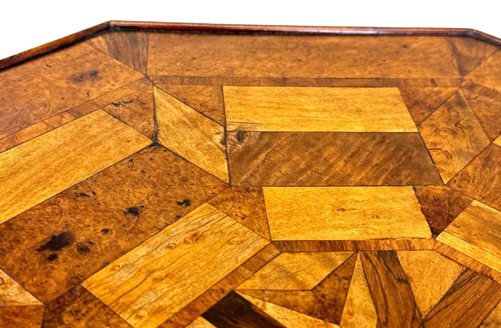 A nineteenth-century octagonal specimen wood occasional table featuring a geometric inlaid tabletop supported by a turned column and carved base. View VII