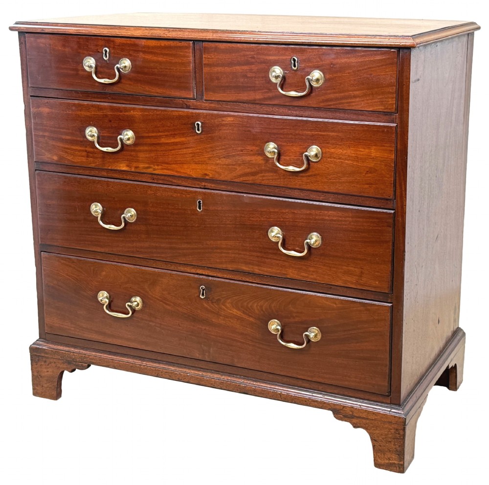 A George III mahogany chest of drawers featuring two short drawers over three long graduated drawers with brass swan-neck handles and bracket feet.