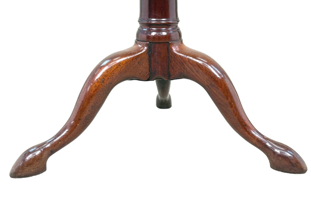 An 18th-century Georgian mahogany tripod table featuring a circular top supported by a central turned column and three splayed legs. View V