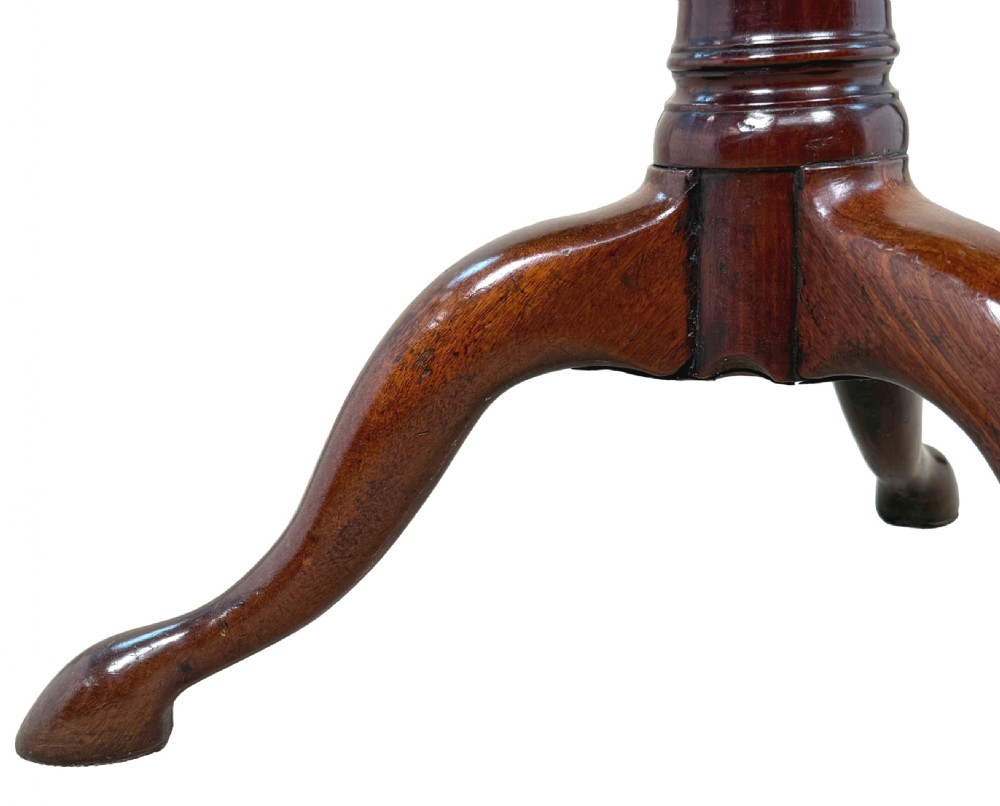 An 18th-century Georgian mahogany tripod table featuring a circular top supported by a central turned column and three splayed legs. View VI