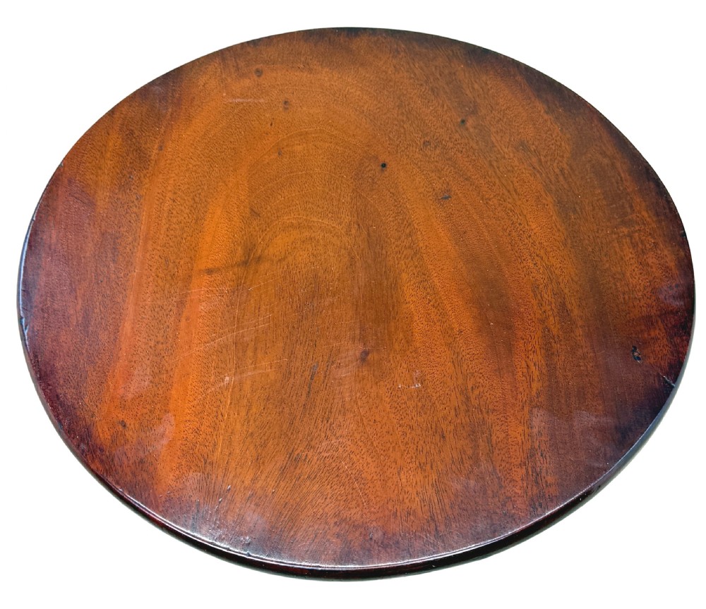 An 18th-century Georgian miniature mahogany tripod table featuring a round top, turned central stem, and three cabriole legs. View II
