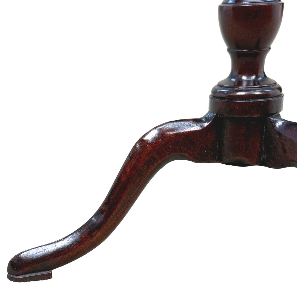 An 18th-century Georgian miniature mahogany tripod table featuring a round top, turned central stem, and three cabriole legs. View VI