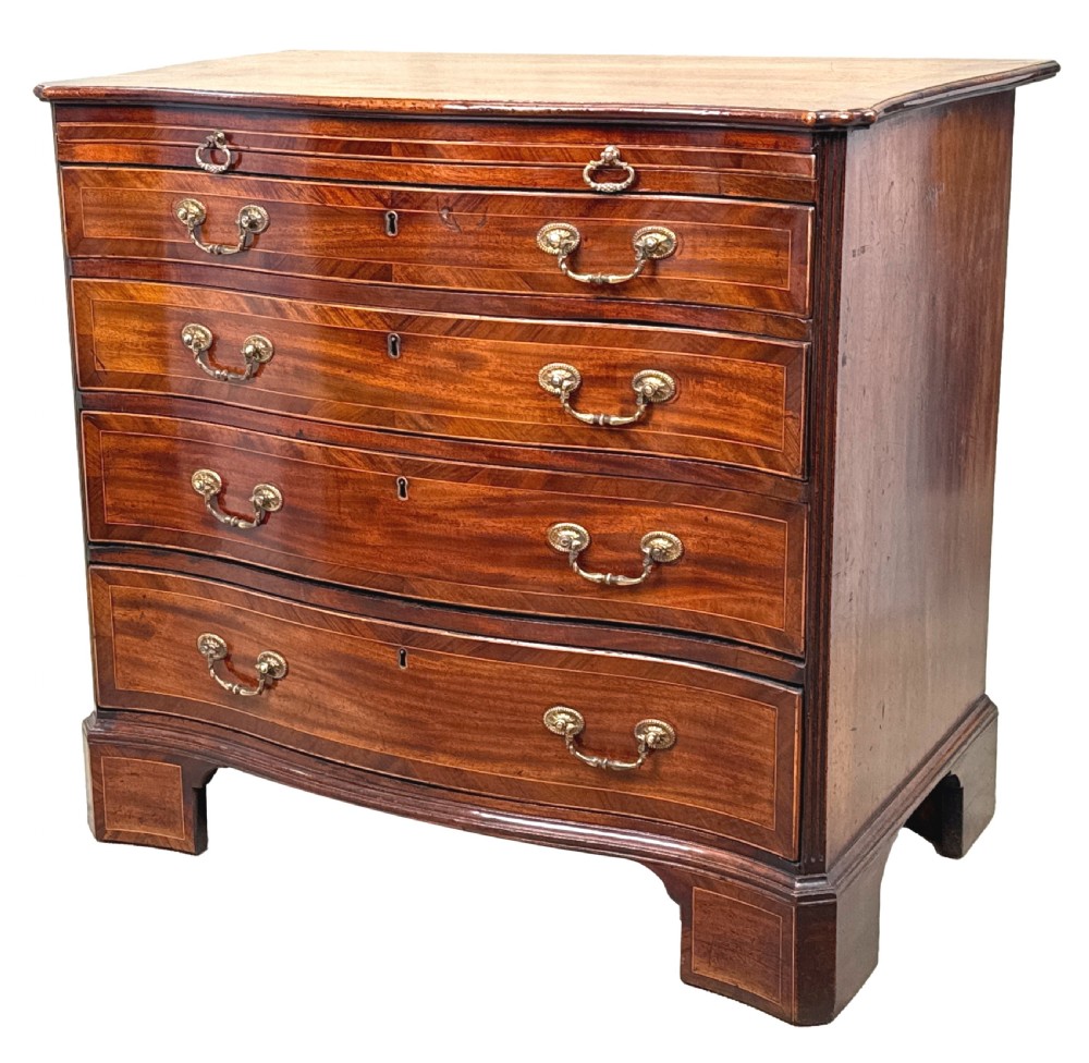 A George III mahogany serpentine chest of drawers featuring four graduated drawers with brass handles and inlaid stringing, supported on bracket feet.