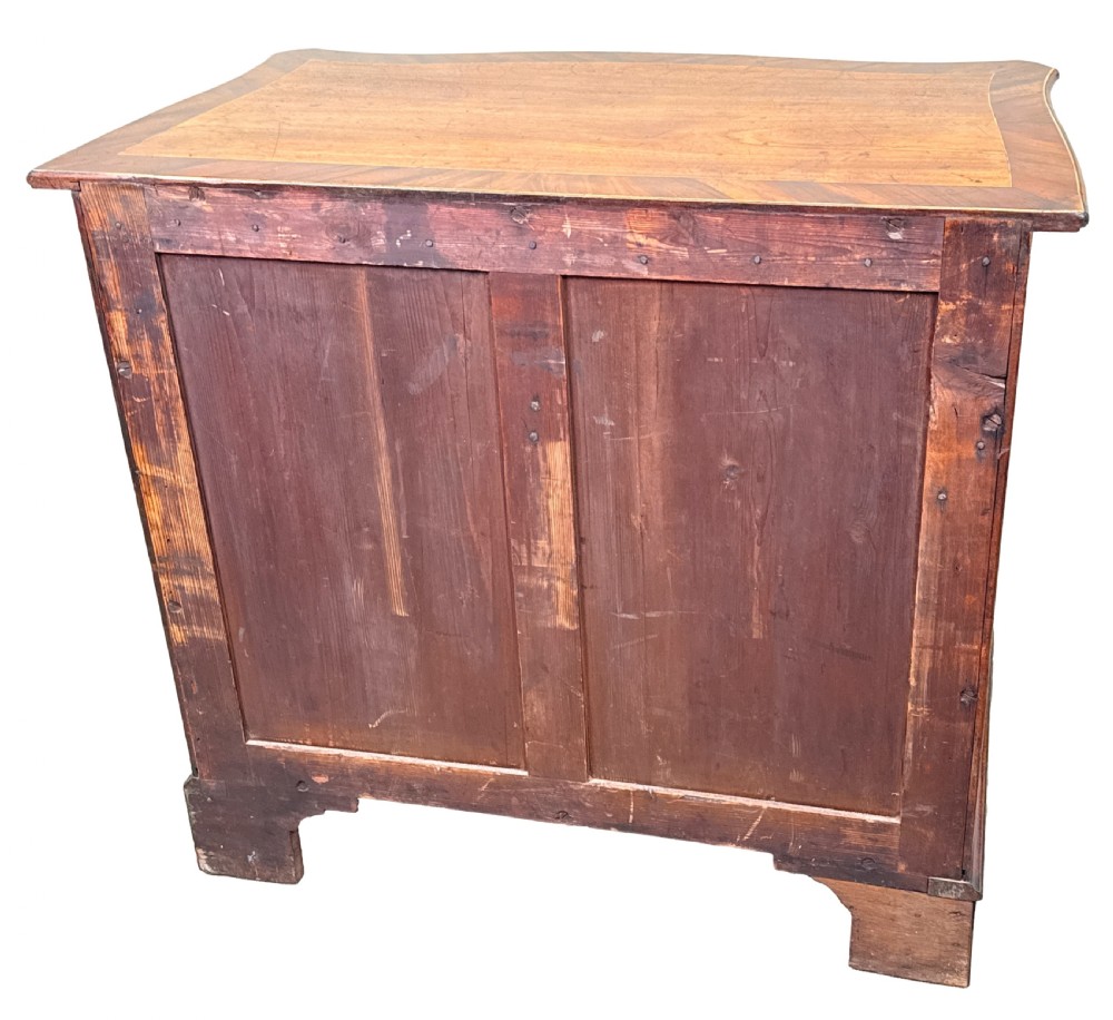 A George III mahogany serpentine chest of drawers featuring four graduated drawers with brass handles and inlaid stringing, supported on bracket feet. View XII