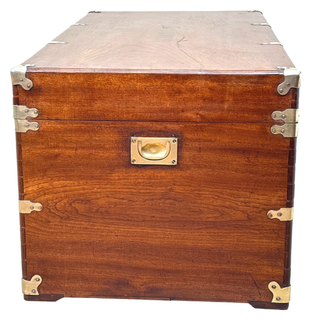 A large nineteenth-century camphor wood campaign trunk featuring brass corner mounts, heavy latches, and exposed dovetail joints. View VIII