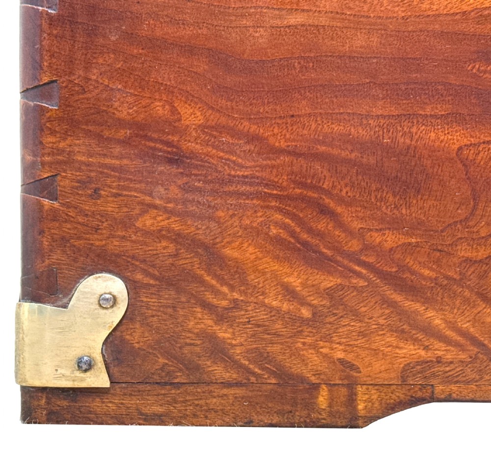 A large nineteenth-century camphor wood campaign trunk featuring brass corner mounts, heavy latches, and exposed dovetail joints. View IX