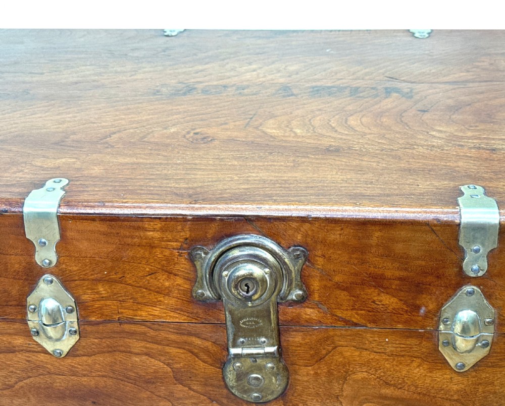 A large nineteenth-century camphor wood campaign trunk featuring brass corner mounts, heavy latches, and exposed dovetail joints. View X