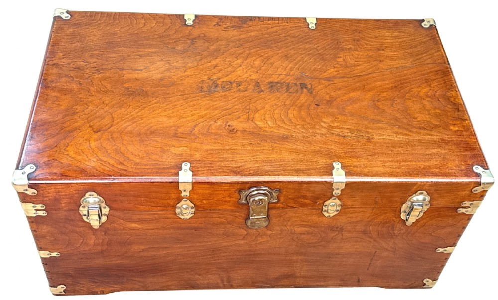 A large nineteenth-century camphor wood campaign trunk featuring brass corner mounts, heavy latches, and exposed dovetail joints. View XI