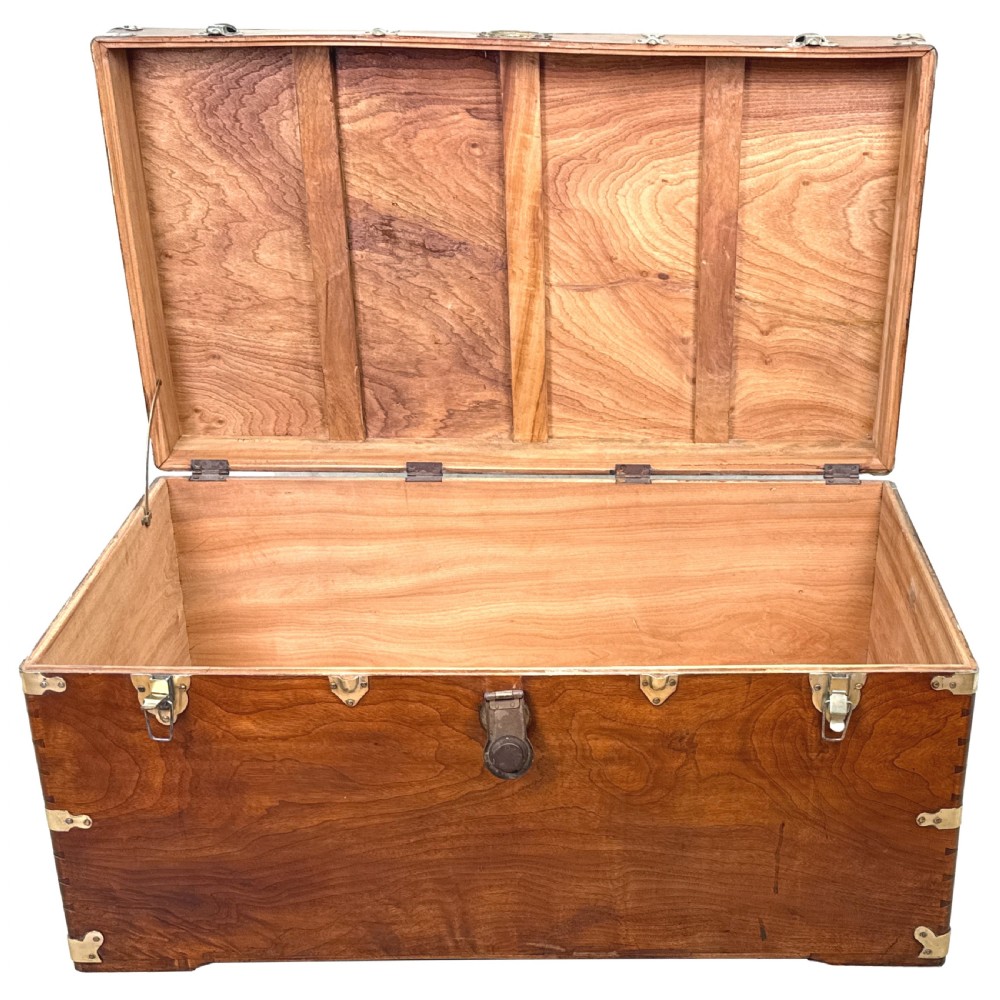 A large nineteenth-century camphor wood campaign trunk featuring brass corner mounts, heavy latches, and exposed dovetail joints. View XII