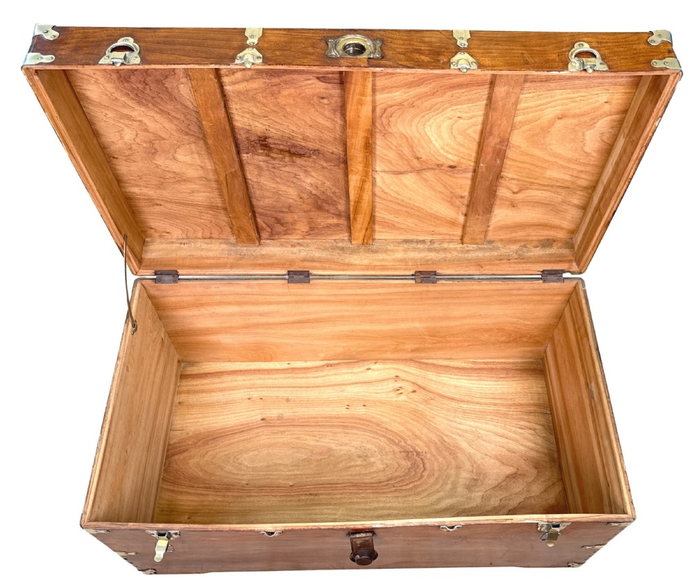 A large nineteenth-century camphor wood campaign trunk featuring brass corner mounts, heavy latches, and exposed dovetail joints. View XIV