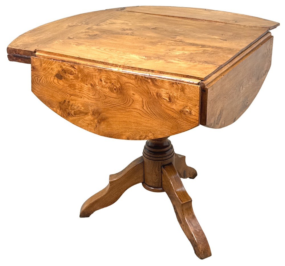 A nineteenth-century French Provincial elm centre table featuring a round top with two drop leaves, a turned central pedestal, and a three-legged tripod base. View II