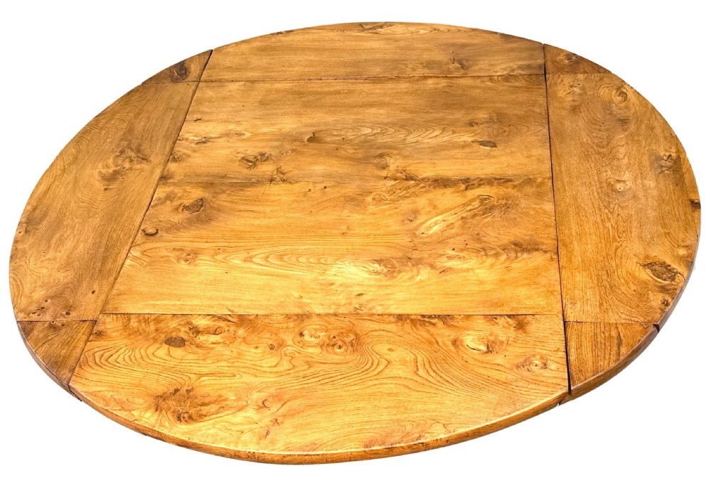 A nineteenth-century French Provincial elm centre table featuring a round top with two drop leaves, a turned central pedestal, and a three-legged tripod base. View III