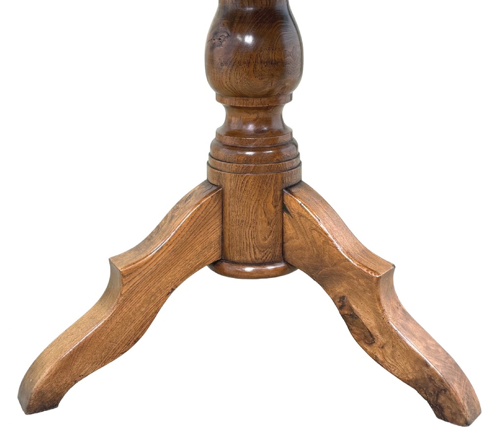 A nineteenth-century French Provincial elm centre table featuring a round top with two drop leaves, a turned central pedestal, and a three-legged tripod base. View IX