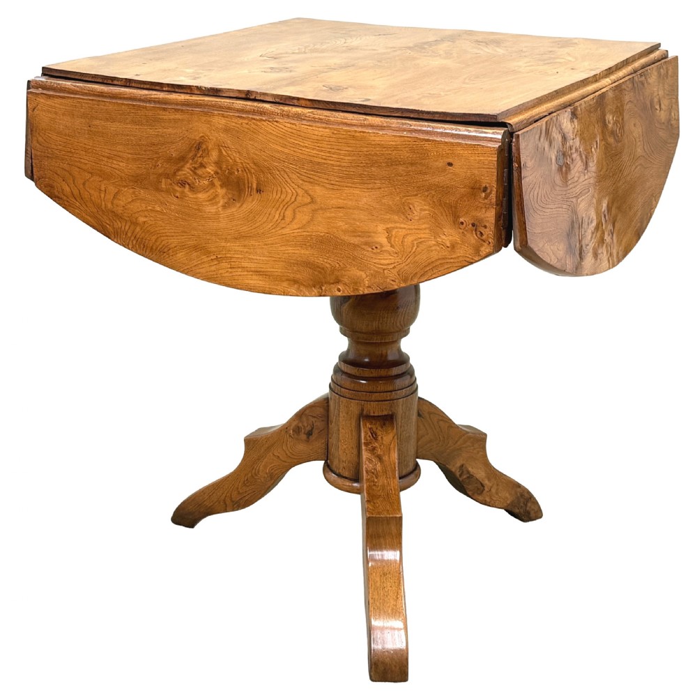 A nineteenth-century French Provincial elm centre table featuring a round top with two drop leaves, a turned central pedestal, and a three-legged tripod base. View XII