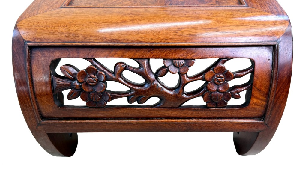 A low-profile 19th-century Oriental hardwood coffee table featuring an intricately carved floral apron and inwardly curved scroll legs. View V