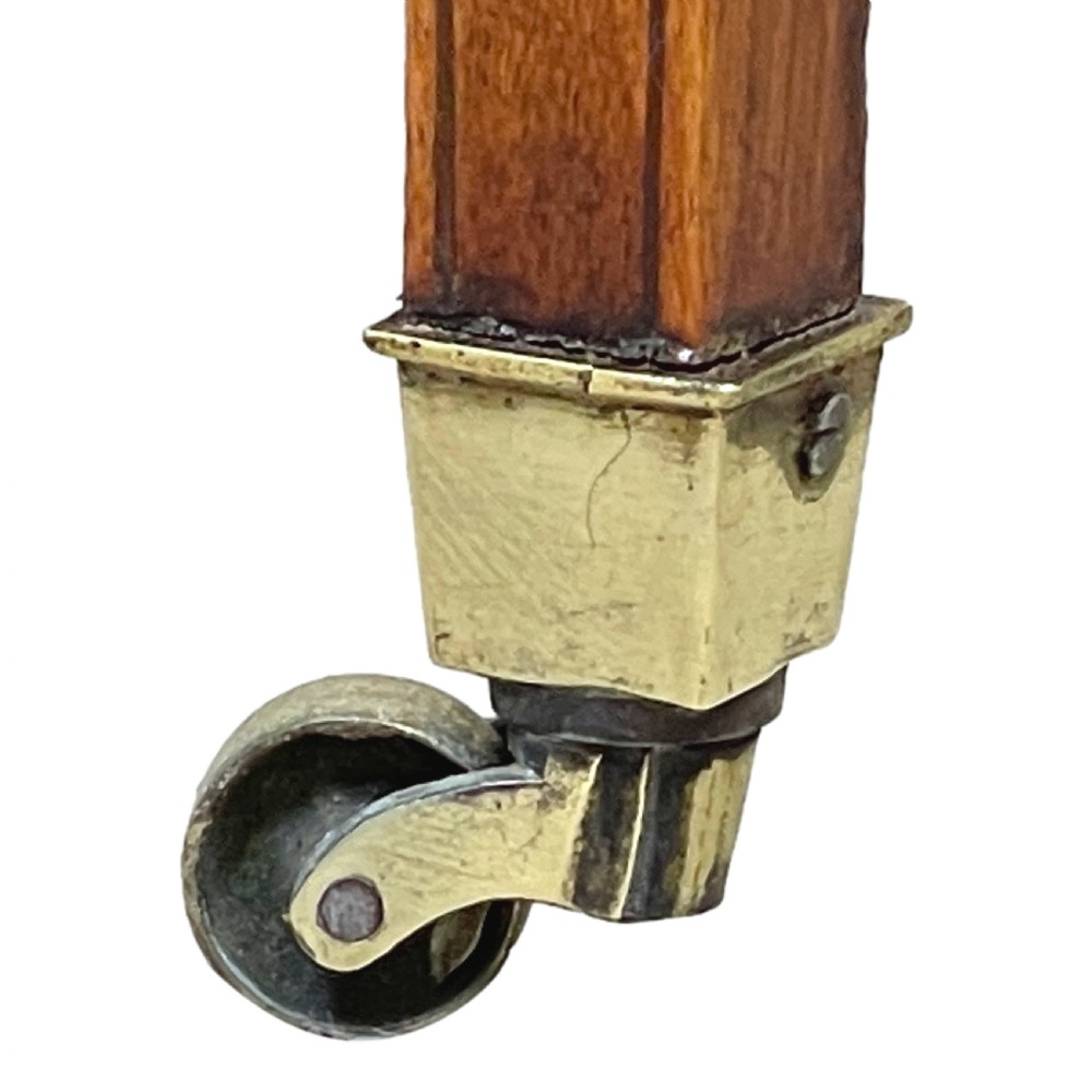 A late 18th-century Georgian satinwood Pembroke table featuring two hinged drop leaves, dark wood crossbanding, a drawer with brass knobs, and tapered square legs with castors. View VII