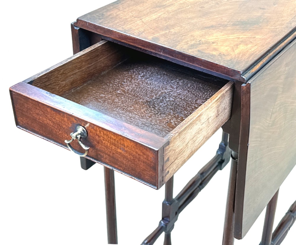 An 18th-century mahogany spider leg table featuring drop leaves, a single frieze drawer with a brass ring handle, and slender turned legs connected by stretchers. View XI