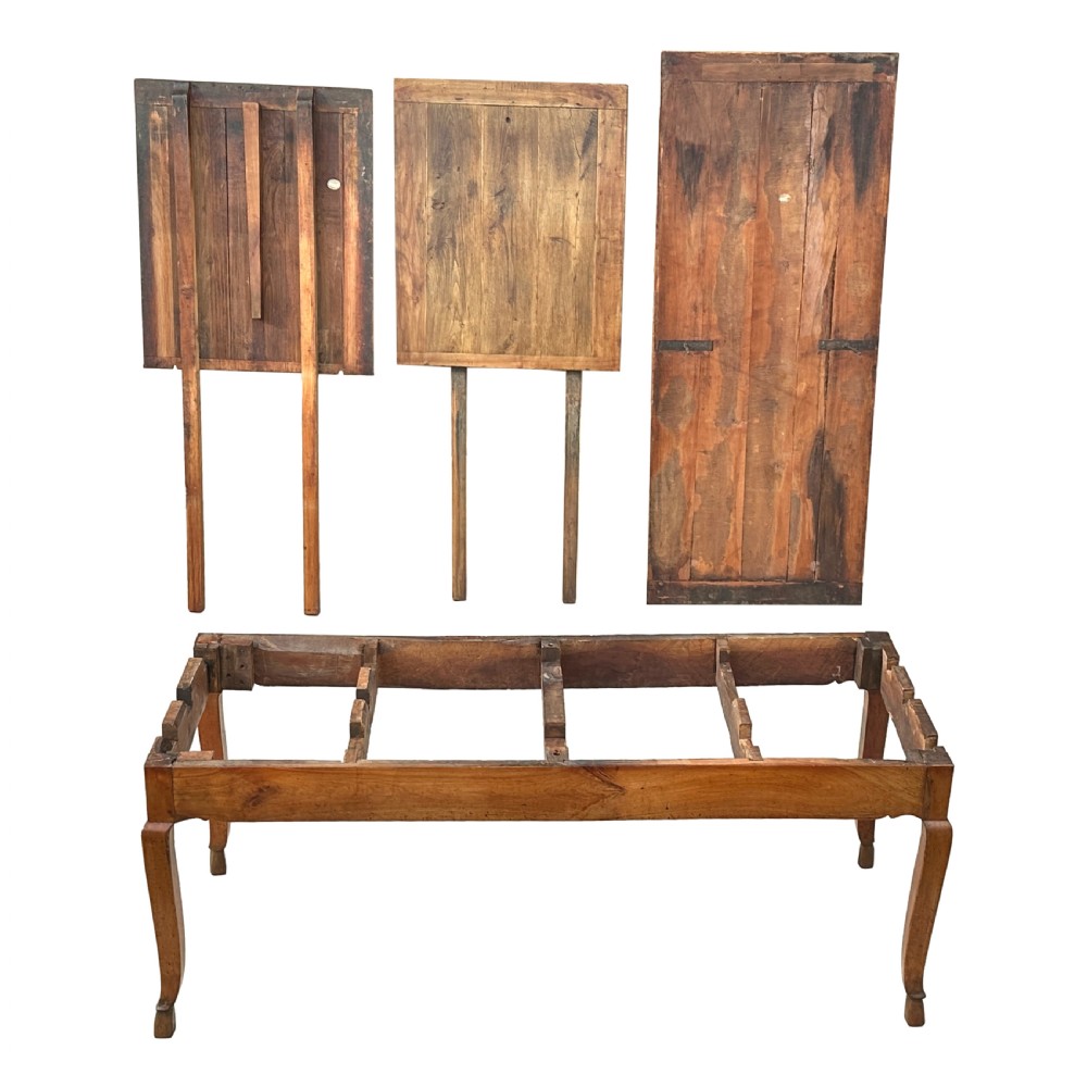 An early 19th-century warm brown extending farmhouse dining table with two end pull-out extensions supported by additional legs. View IV
