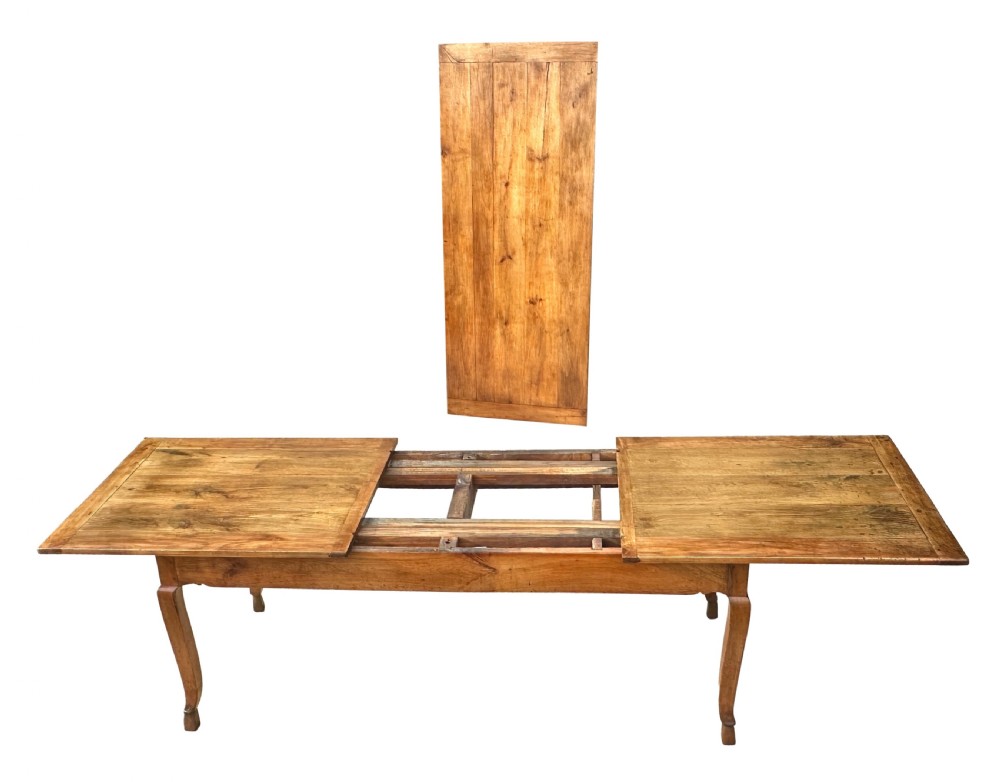 An early 19th-century warm brown extending farmhouse dining table with two end pull-out extensions supported by additional legs. View VIII
